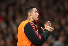  Cristiano Ronaldo of Manchester United warms up on the touchline during the Premier League match  (Photo by Alex Pantling/Getty Images)