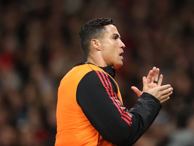  Cristiano Ronaldo of Manchester United warms up on the touchline during the Premier League match  (Photo by Alex Pantling/Getty Images)
