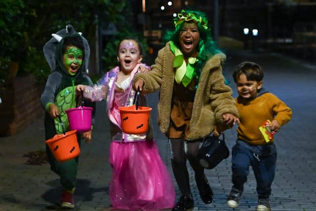 Children pose for a picture as they go trick-or-treating for Halloween in east London.