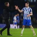 Graham Potter, Manager of Brighton & Hove Albion shakes hands with Adam Webster as they celebrate at full-time (Photo by Mike Hewitt/Getty Images)