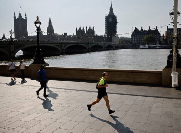 <p>A jogger runs along the south bank of the River Thames, opposite the Houses of Parliament</p>