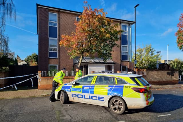 Police officers guarding one of the closed roads at the crime scene. Photo: LondonWorld