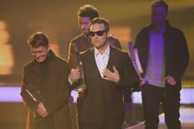 Robbie Williams and other members of the UK band "Take That" walk offstage after receiving their International Band Rock/Pop Award at the Echo Awards 201