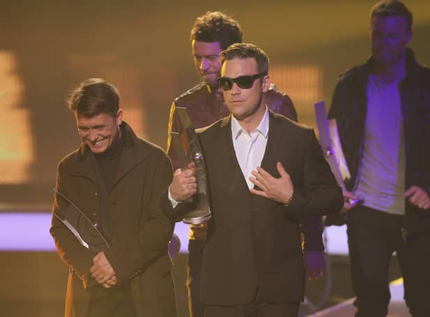 Robbie Williams and other members of the UK band "Take That" walk offstage after receiving their International Band Rock/Pop Award at the Echo Awards 201