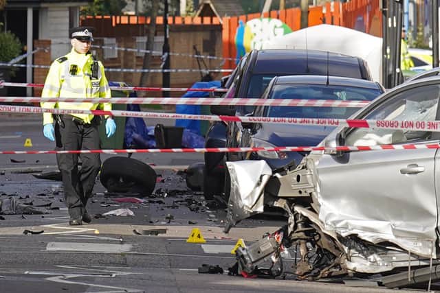 Police at the scene on Railton Road in Lambeth, south London, where two men have died after gunshots were heard on Sunday evening. Credit: PA