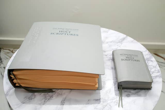 One chapter of the Bible, on the left, in Braille, compared to an entire ink printed bible on the right. Photo: SWNS
