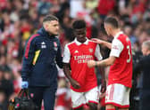 Bukayo Saka of Arsenal is comferted by Granit Xhaka as he leaves the pitch following an injury during the Premier League match  (Photo by Alex Pantling/Getty Images)