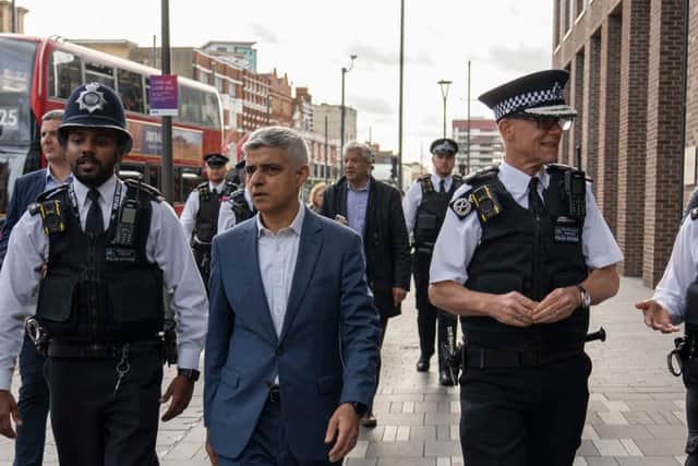 Mayor Sadiq Khan, second from left, and Sir Mark Rowley, second from right, with Met Police officers. Photo: Met Police