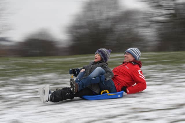 Children play in the snow on Primrose Hill in London. Photo: Getty