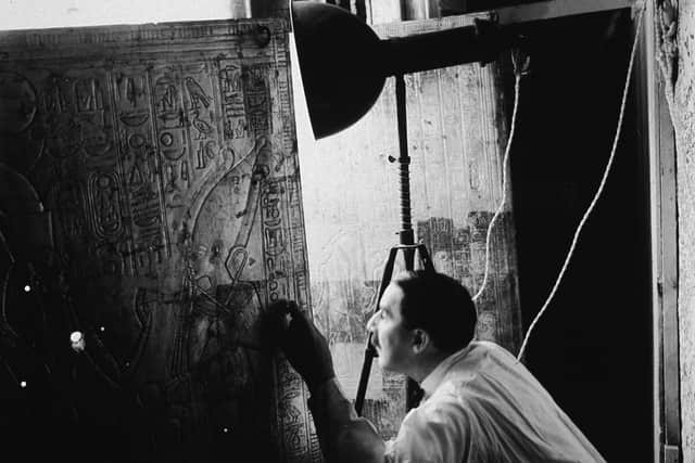 British archaeologist Howard Carter (1874 - 1939) opens the doors of the second of four gold shrines surrounding the sarcophagus of Pharaoh Tutankhamen