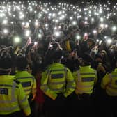 Police officers form a cordon as well-wishers gather at a vigil in honour of murder victim Sarah Everard. Photo: Getty