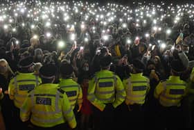 Police officers form a cordon as well-wishers gather at a vigil in honour of murder victim Sarah Everard. Photo: Getty