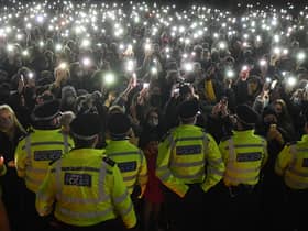 Police officers form a cordon as well-wishers gather at a vigil in honour of murder victim Sarah Everard. Photo: Getty