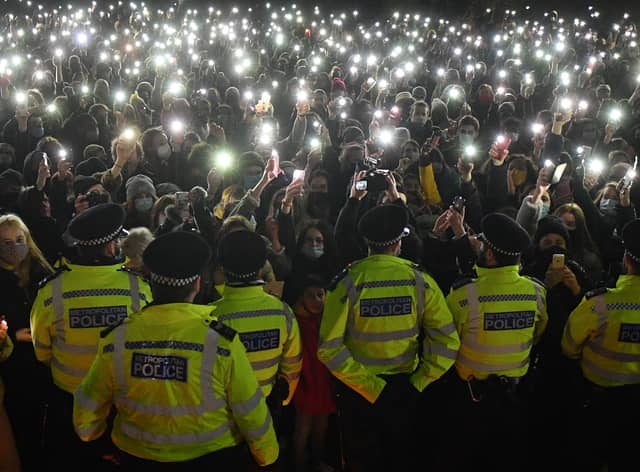 Police officers form a cordon as well-wishers gather at a vigil in honour of murder victim Sarah Everard. Photo: Getty