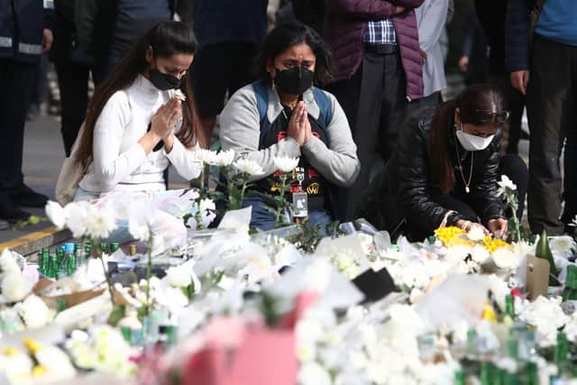 People pay tribute to the victims of the Halloween celebration stampede, November 01, 2022 in Seoul, South Korea.