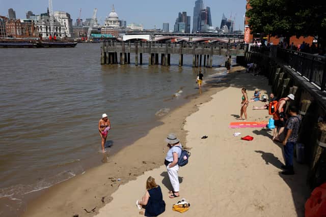 Cooling off at the River Thames during a record-breaking heatwave in central London. Photo: Getty