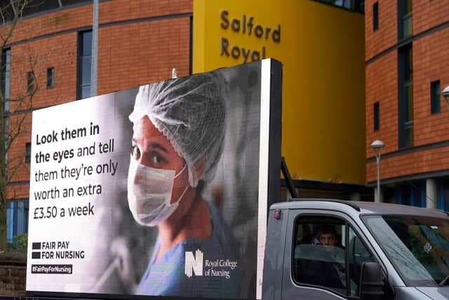 Responding to the government’s NHS pay proposal, the Royal College of Nursing has released a digital billboard message showing the image of a nurse in PPE with the message: ‘Look them in the eyes and tell them they’re only worth an extra £3.50 a week’ outside the Salford Royal hospital.