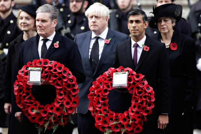 Labour Party leader Keir Starmer and prime minister Rishi Sunak stand with their poppy wreaths. Photo: Getty