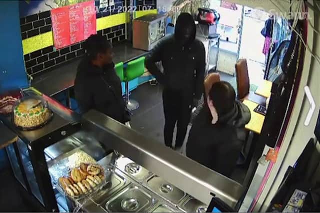 Mr Cools can be seen wrestling the attacker who is wearing a black jacket with a hood over his head. Photo: Julius Cools/ SWNS