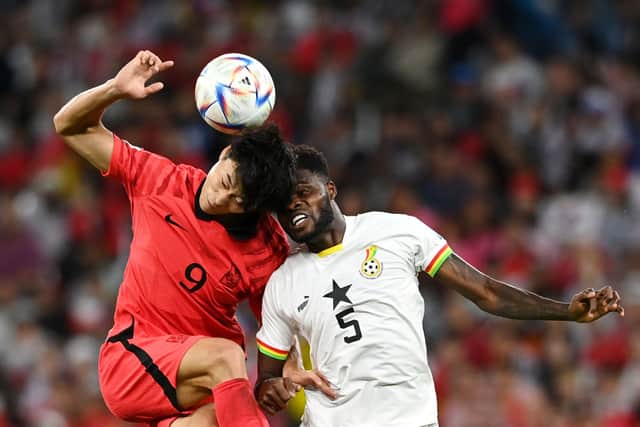 Guesung Cho of Korea Republic competes for a header against Thomas Partey. Credit: Claudio Villa/Getty Images