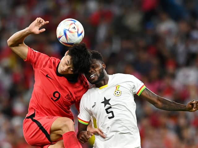Guesung Cho of Korea Republic competes for a header against Thomas Partey. Credit: Claudio Villa/Getty Images