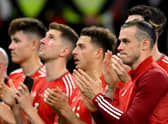 Wales’ forward Gareth Bale and teammates applaud Wales supporters after their defeat against England (Photo by NICOLAS TUCAT/AFP via Getty Images)