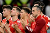 Wales’ forward Gareth Bale and teammates applaud Wales supporters after their defeat against England (Photo by NICOLAS TUCAT/AFP via Getty Images)