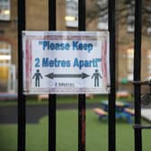 A social distancing sign hangs on a primary school gate in the Borough of Lewisham on January 04, 2021 in London, England. 