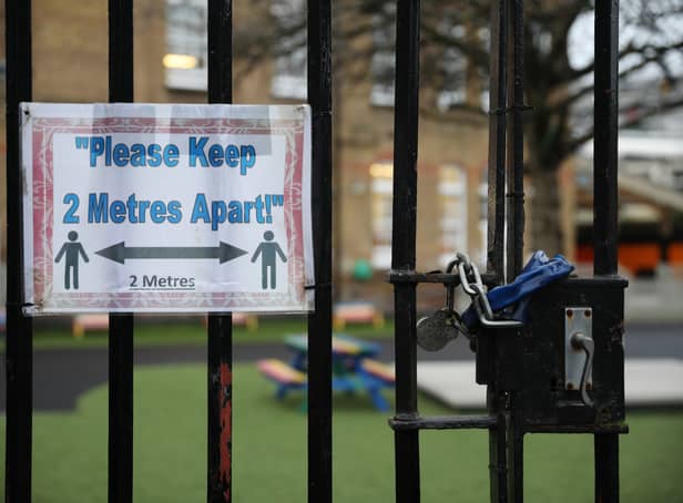 <p>A social distancing sign hangs on a primary school gate in the Borough of Lewisham on January 04, 2021 in London, England. </p>