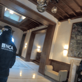 National Crime Agency officers during raid the London home of a wealthy Russian businessman.  Credit: NCA