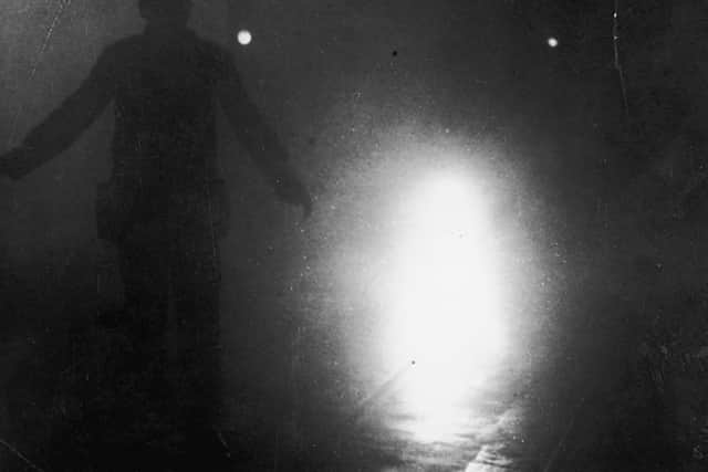 A London bus conductor is forced to walk ahead of his vehicle to guide it through the smog, December 9 1952. Credit: Getty Images