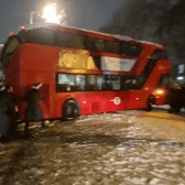Londoners banded together to move a double-decker bus that got stuck during heavy snowfall. Photo: SWNS