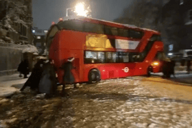 Londoners banded together to move a double-decker bus that got stuck during heavy snowfall. Photo: SWNS