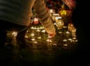 An organised candelit vigil at Babbs Mill Lake where a group of children fell through the ice on Sunday. Three of those children have died while a fourth, aged six, is fighting for his life in hospital.