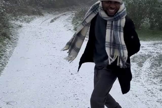 The wholesome video shows Noel Bako, 27, all smiles and prancing through a thin layer  of snow after freezing temperatures hit the UK. Photo: Jaima Bako/ SWNS