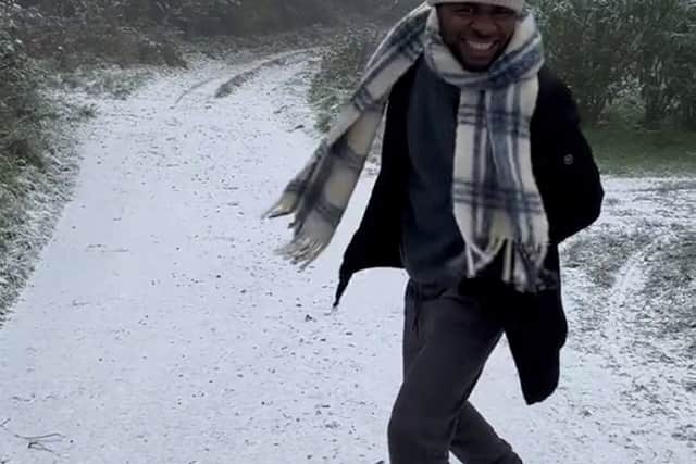 The wholesome video shows Noel Bako, 27, all smiles and prancing through a thin layer of snow after freezing temperatures hit the UK. Photo: Jaima Bako/ SWNS