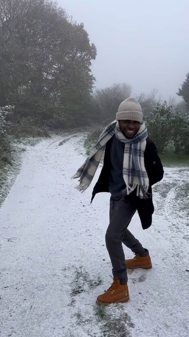 The wholesome video shows Noel Bako, 27, all smiles and prancing through a thin layer of snow after freezing temperatures hit the UK. Photo: Jaima Bako/ SWNS