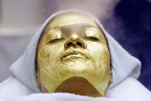 Stock image of a woman receiving a gold facial treatment. Photo: Getty