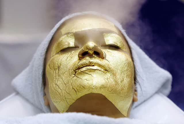 Stock image of a  woman receiving a gold facial treatment. Photo: Getty