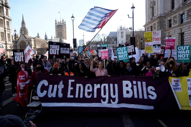 Demonstrators hold up placards during a march to demand action to tackle the cost of living crisis. Photo: Getty