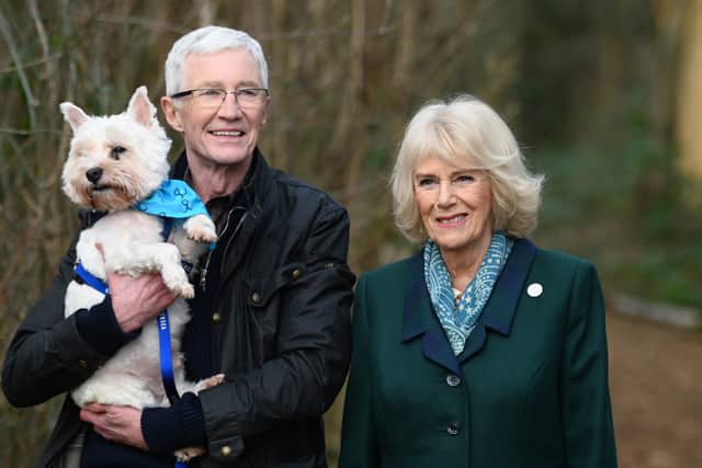 Camilla, Duchess of Cornwall, patron of Battersea Dogs and Cats Home and Battersea Ambassador Paul OâGrady on a brief woodland walk with a rescue dog which is yet to be re-homed, during her visit to Battersea Brand Hatch Centre on February 2, 2022 in Ash, England. (Photo by Stuart C. Wilson - WPA Pool/Getty Images)