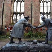 A resin model of a sculpture illustrating the WW1 Christmas Truce football match is pictured during a photocall inside the remains of St Luke's Church in Liverpool