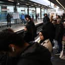 Commuters wait for an extremely delayed Central Line train at Stratford station in London on December 13  as rail strikes began a wave of festive walkouts in the country.