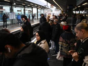 Commuters wait for an extremely delayed Central Line train at Stratford station in London on December 13  as rail strikes began a wave of festive walkouts in the country.