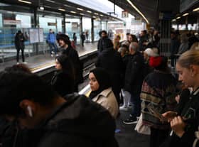 Commuters wait for an extremely delayed Central Line train at Stratford station in London on December 13  as rail strikes began a wave of festive walkouts in the country.