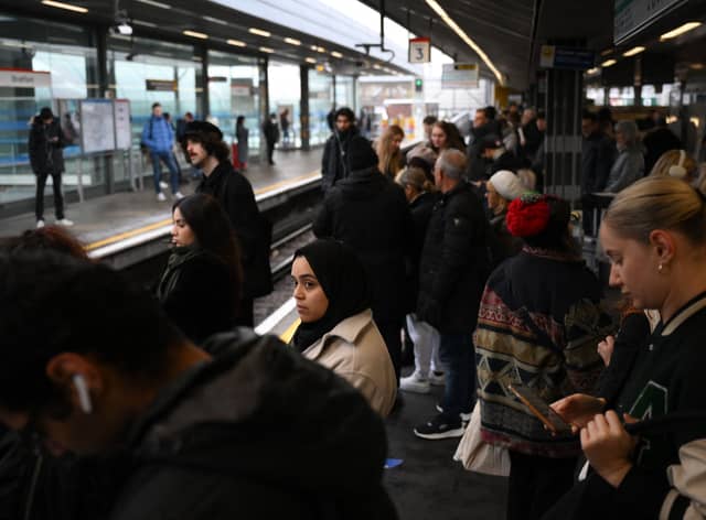 Commuters wait for an extremely delayed Central Line train at Stratford station in London on December 13  as rail strikes began a wave of festive walkouts in the country.