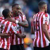 Ivan Toney and Rico Henry of Brentford celebrate after their sides victory during the Premier League match between Manchester City and Brentford