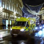An ambulance queues in traffic beneath the Christmas decorations on Regent Street. Photo: Getty