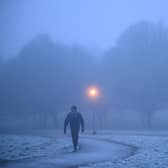 A walker makes their way through fog on a frosty morning at Primrose Hill in north London. (Photo by Justin TALLIS / AFP) (Photo by JUSTIN TALLIS/AFP via Getty Images)