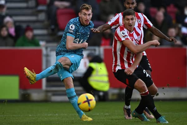 ottenham Hotspur's Swedish midfielder Dejan Kulusevski (L) has this shot saved during the English Premier League football match between Brentford and Tottenham Hotspur 